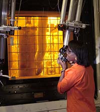 Employees perform operations remotely, from outside shielded windows.