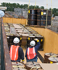 Drums containing depleted uranium oxide being loaded into railroad cars bound for a waste treatment plant in Utah.